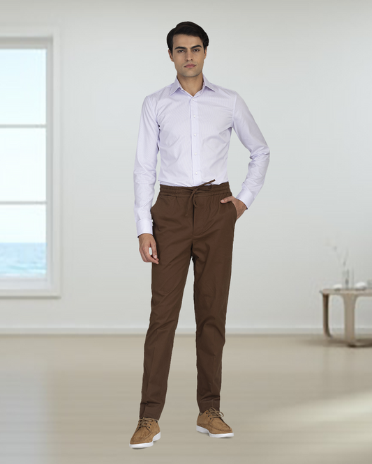 Model wearing custom Genoa drawstring pants for men by Luxire in coffee brown