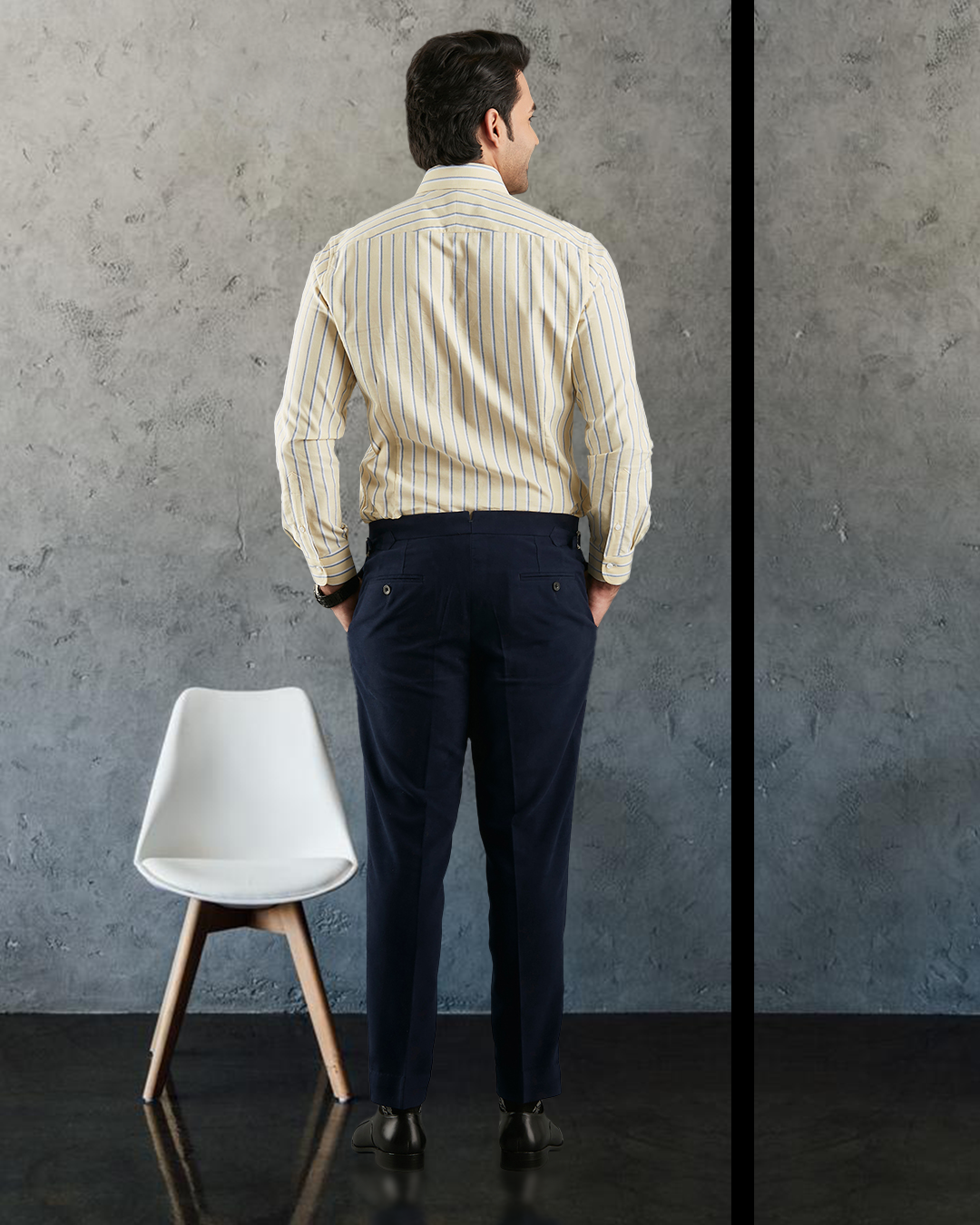Back of model wearing the custom oxford shirt for men by Luxire in pale yellow with indigo and white stripes