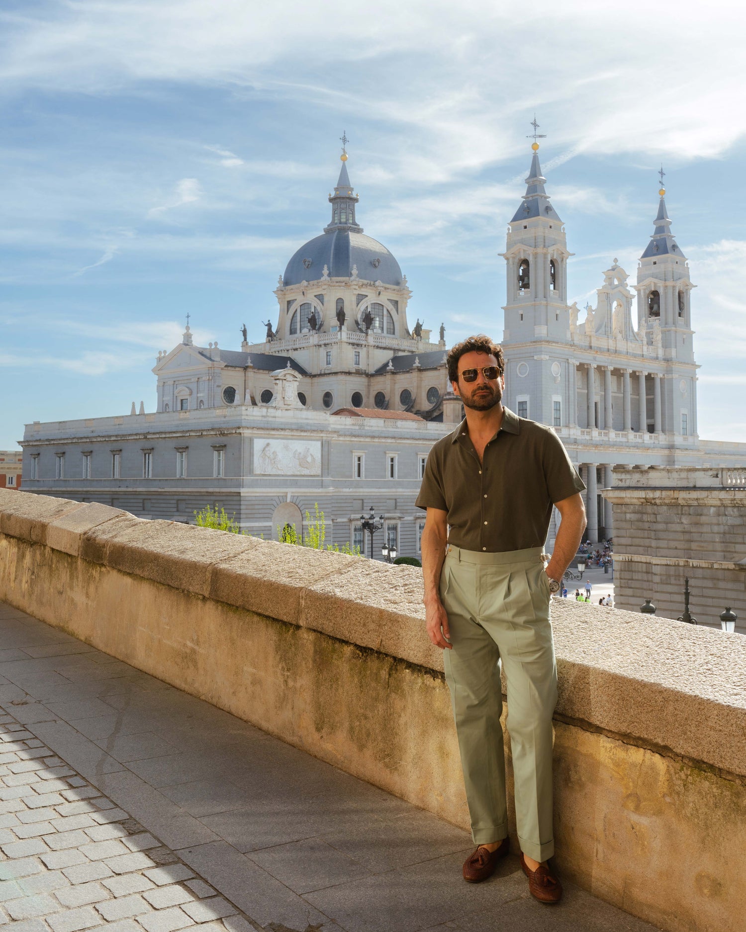 Model outside wearing mens custom polo cotton camp shirt by Luxire in olive green