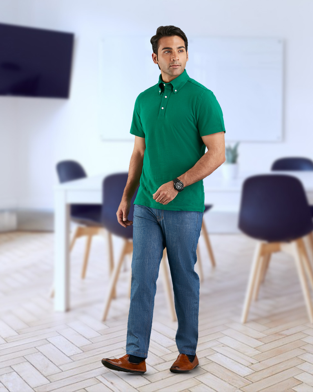 Model wearing the custom oxford polo shirt for men by Luxire in racing green hand at side