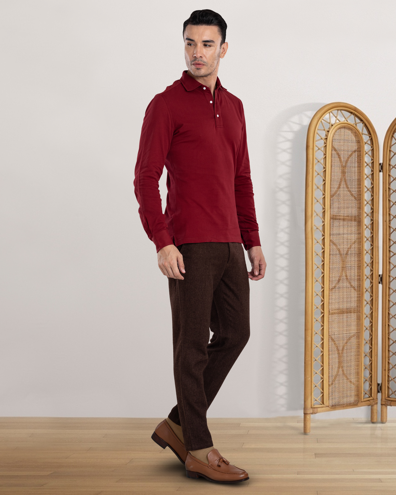 Side view of model wearing the custom oxford polo shirt for men by Luxire in maroon