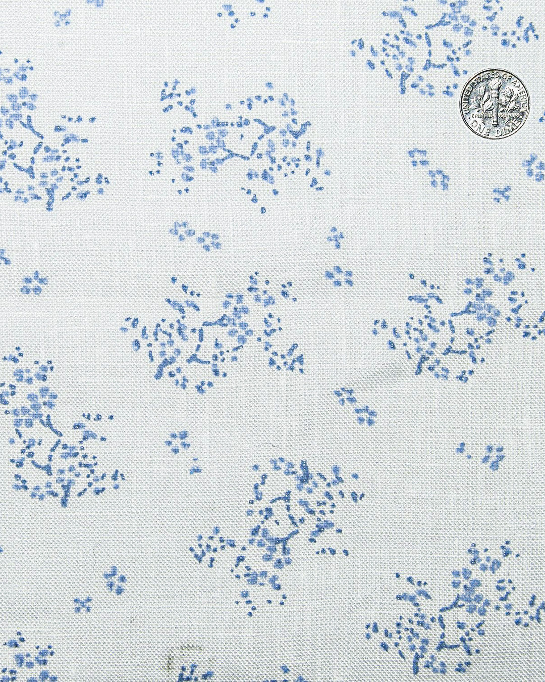 Close up view of custom linen shirt for men in pale blue printed shrubs