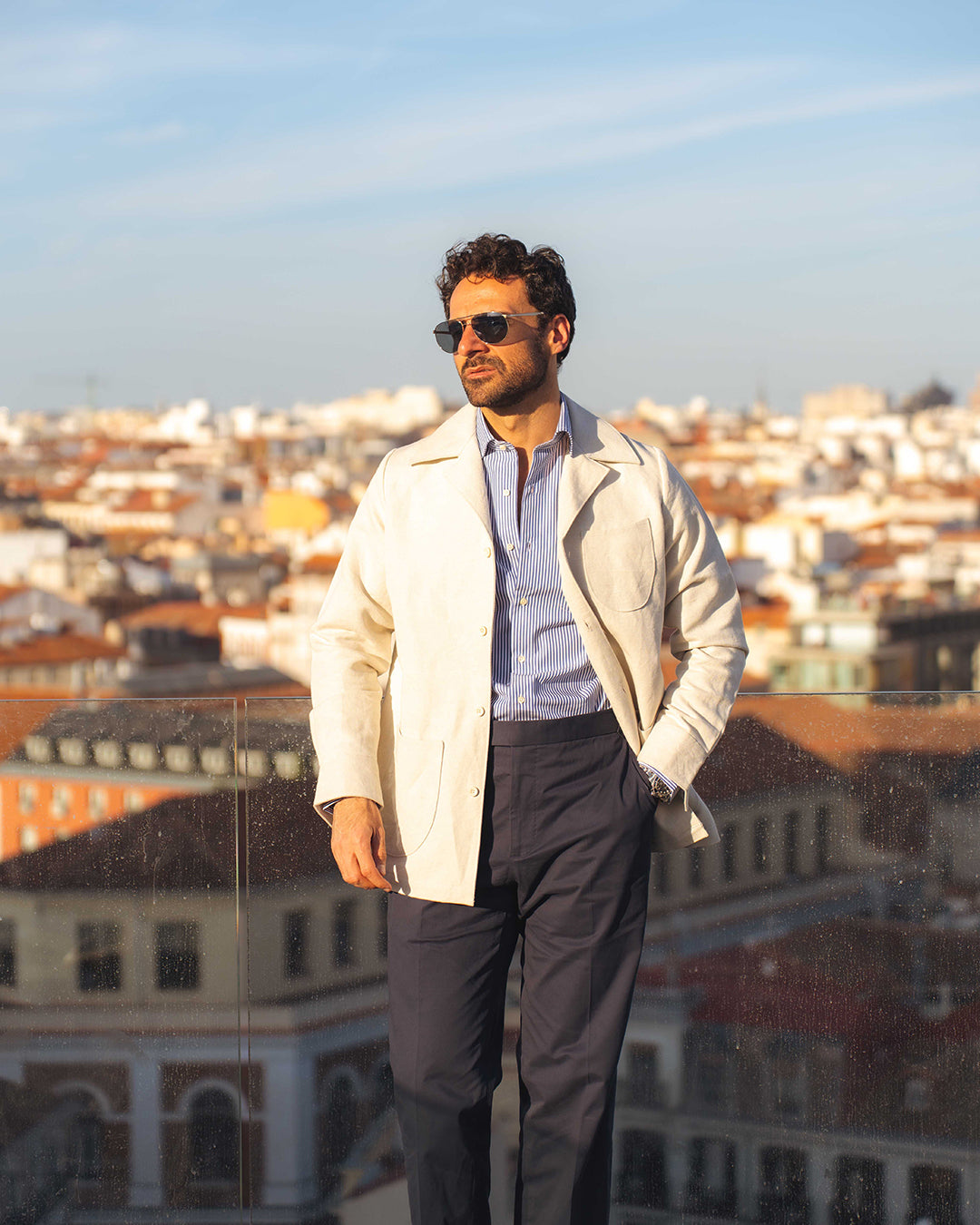 Model outside wearing the linen shirt jacket for men by Luxire in cream wearing sunglasses 9