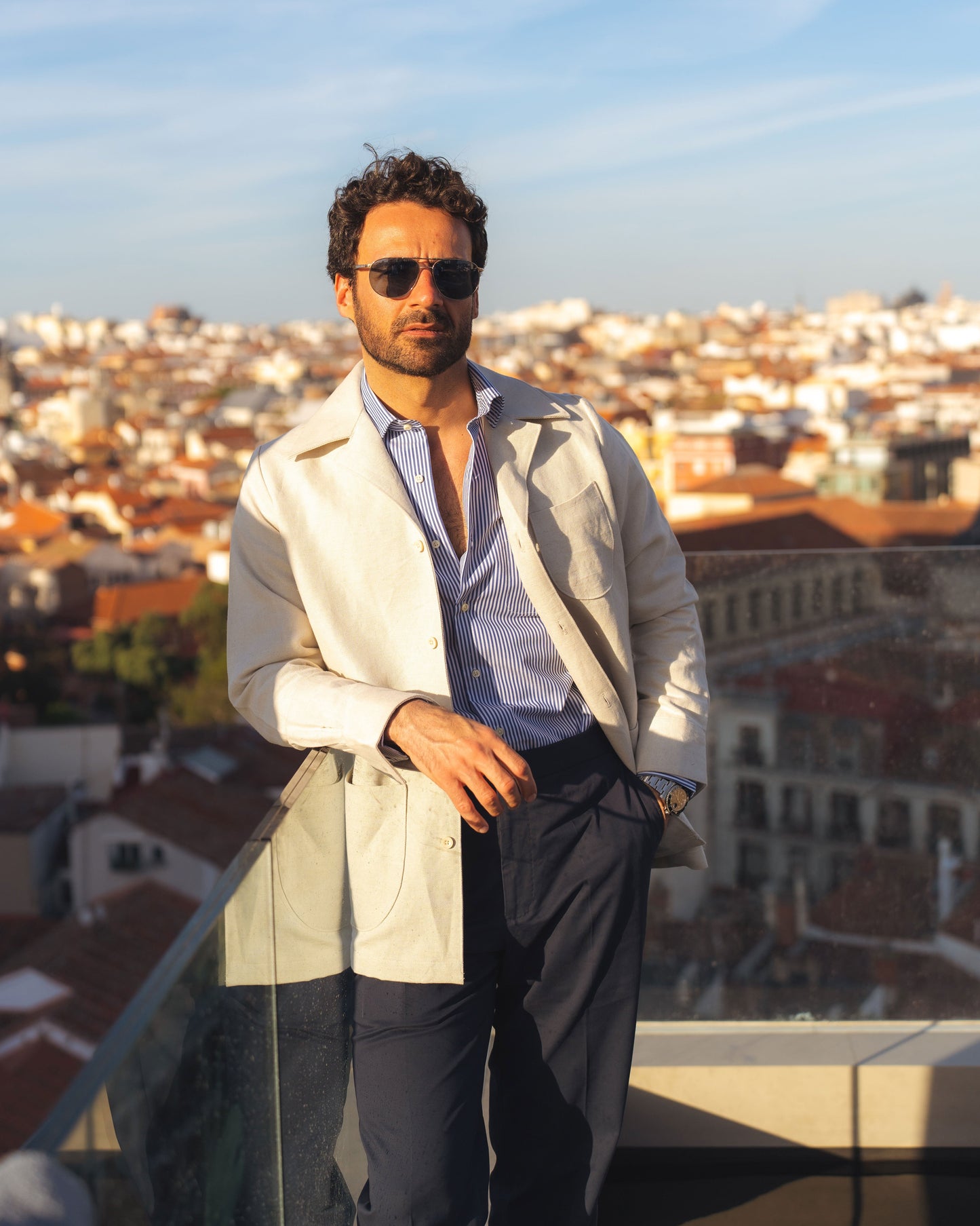 Model outside wearing the linen shirt jacket for men by Luxire in cream wearing sunglasses 13