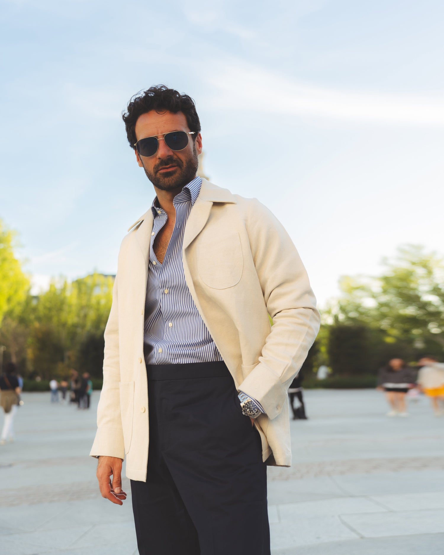 Model outside wearing the linen shirt jacket for men by Luxire in cream wearing sunglasses 15