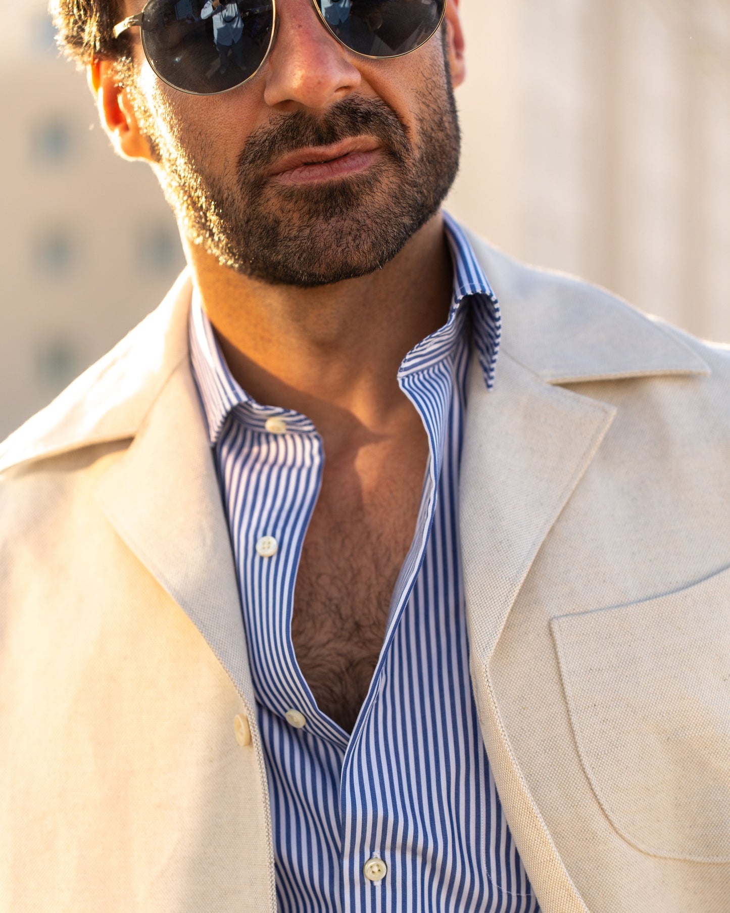 Model outside wearing the linen shirt jacket for men by Luxire in cream wearing sunglasses