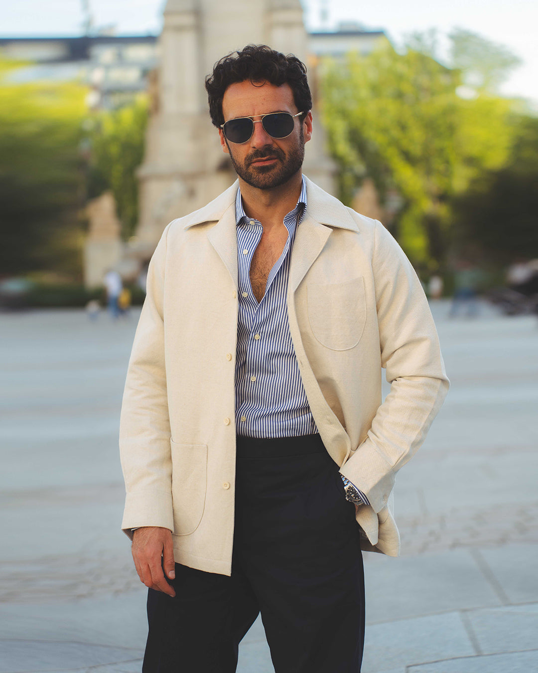 Model outside wearing the linen shirt jacket for men by Luxire in cream wearing sunglasses 2