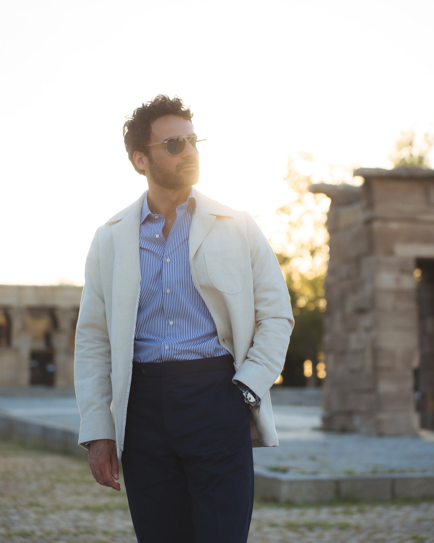 Model outside wearing the linen shirt jacket for men by Luxire in cream wearing sunglasses 3