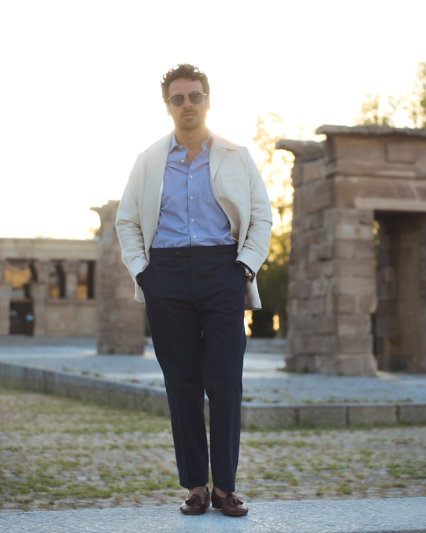 Model outside wearing the linen shirt jacket for men by Luxire in cream wearing striped shirt 10