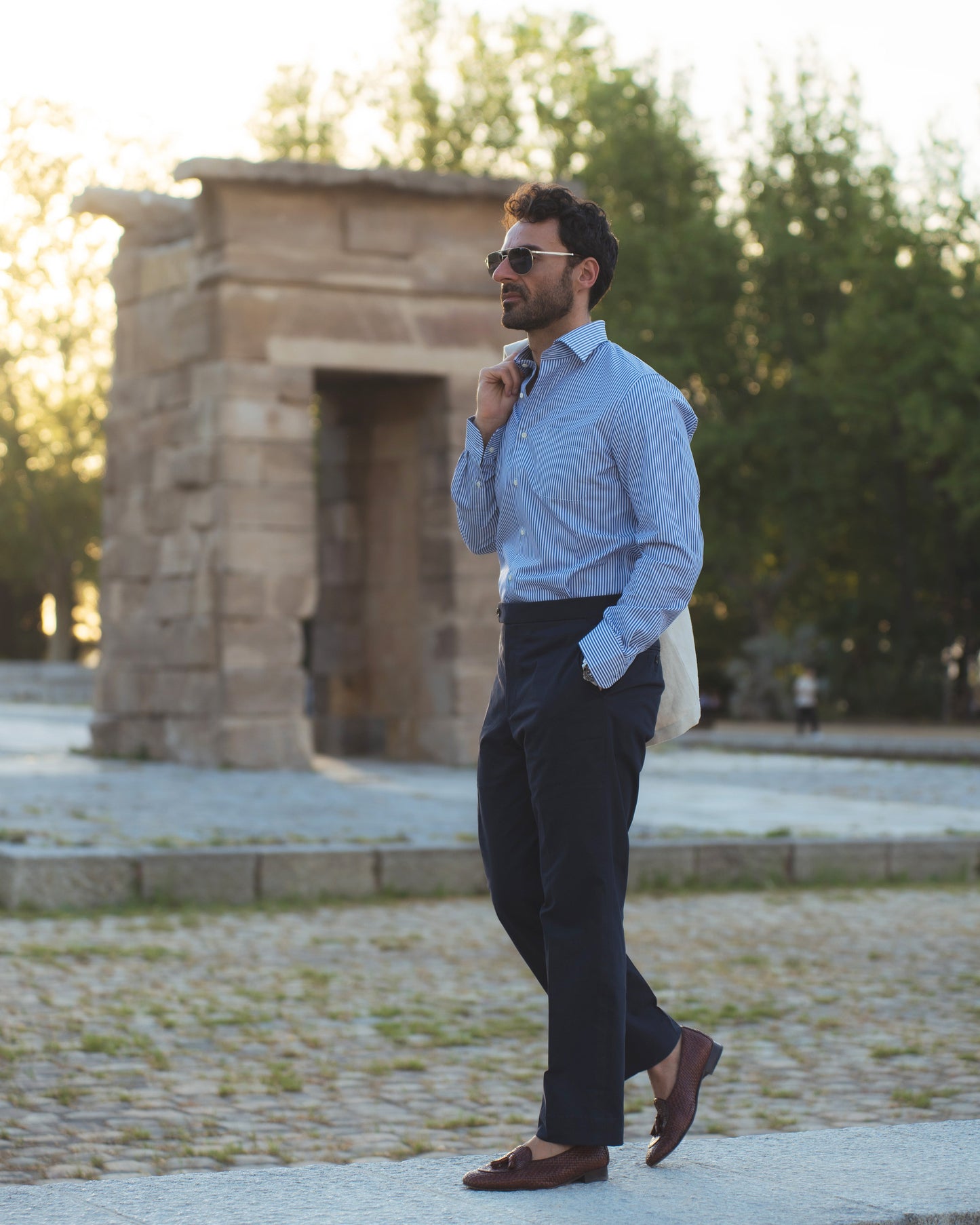 Model outside wearing the linen shirt jacket for men by Luxire in cream wearing striped shirt 12