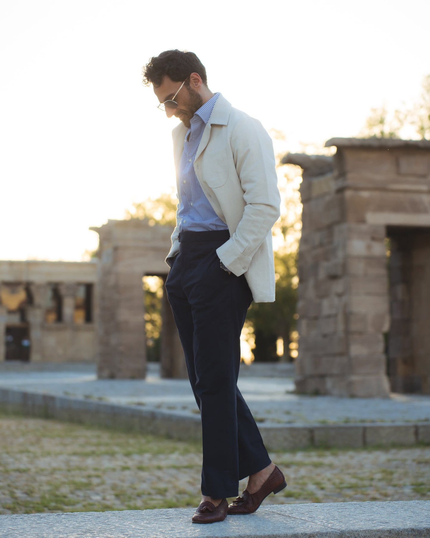 Model outside wearing the linen shirt jacket for men by Luxire in cream wearing striped shirt 14