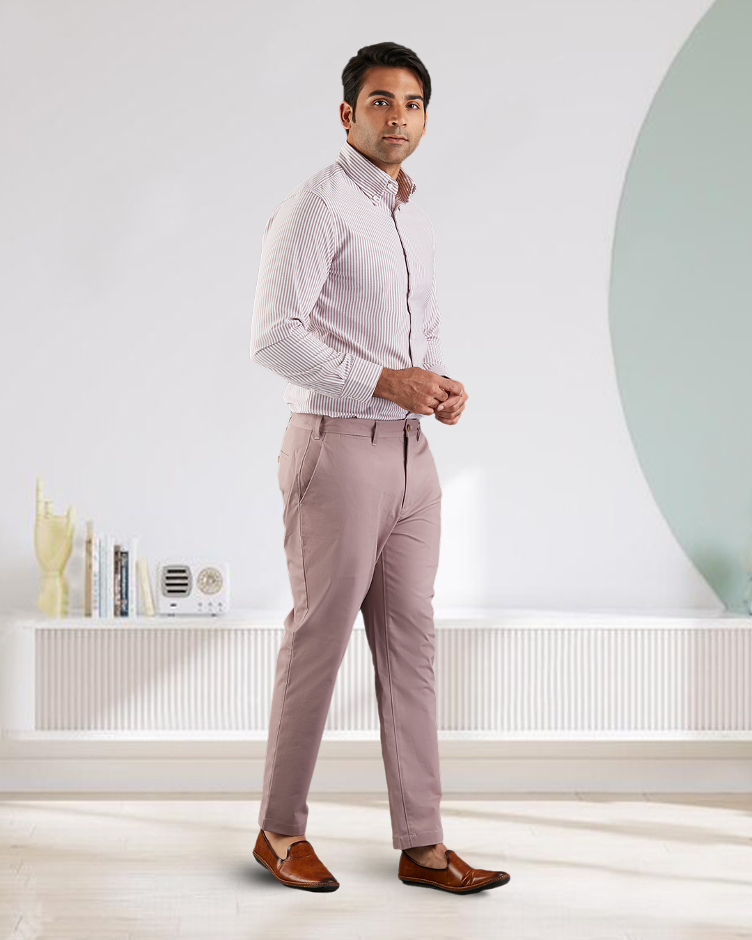Side view of model wearing custom Genoa Chino pants for men by Luxire in purple fade hands together