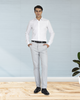 Model wearing custom Genoa Chino pants for men by Luxire in light grey hands in pockets