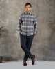 Model wearing custom check shirts for men by Luxire dark grey and navy hands in pockets