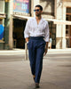 Male model outside wearing custom linen Gurkha pants for men by Luxire in dark indigo wearing sunglasses