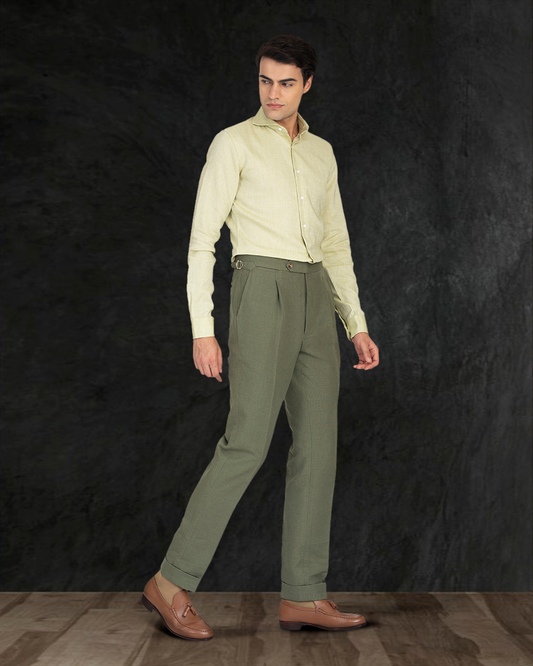 Male model wearing custom linen canvas pants for men by Luxire in olive green