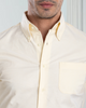 Close up of model wearing the custom oxford shirt for men by Luxire in pale yellow