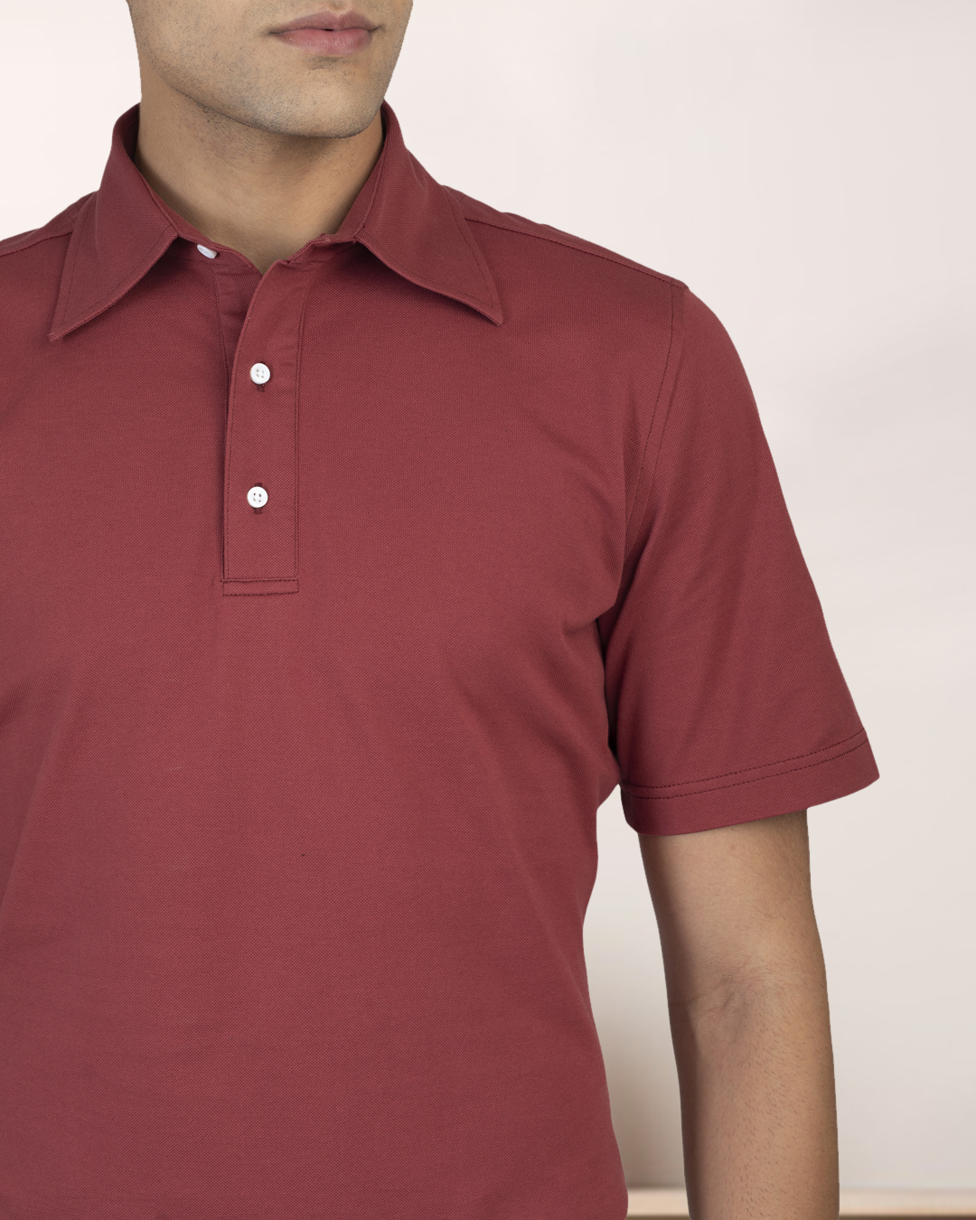 Close up of model wearing the custom oxford polo shirt for men by Luxire in soft marsala