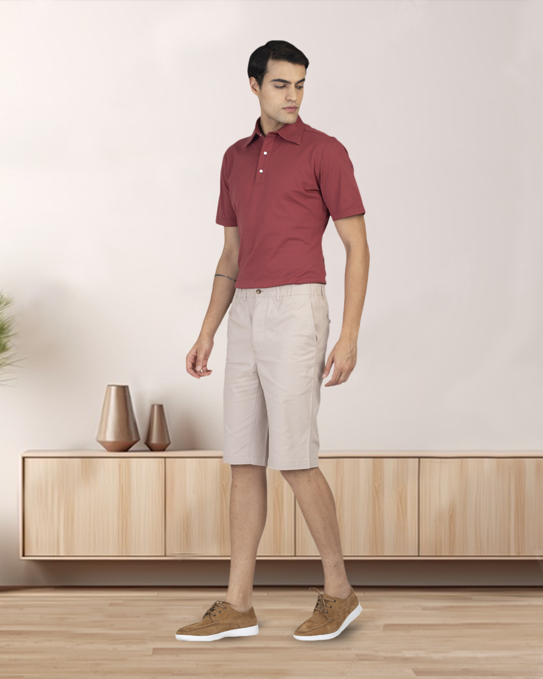 Front of model wearing the custom oxford polo shirt for men by Luxire in soft marsala hands at side 2