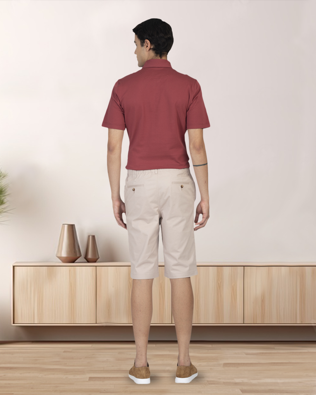 Back of model wearing the custom oxford polo shirt for men by Luxire in soft marsala 2
