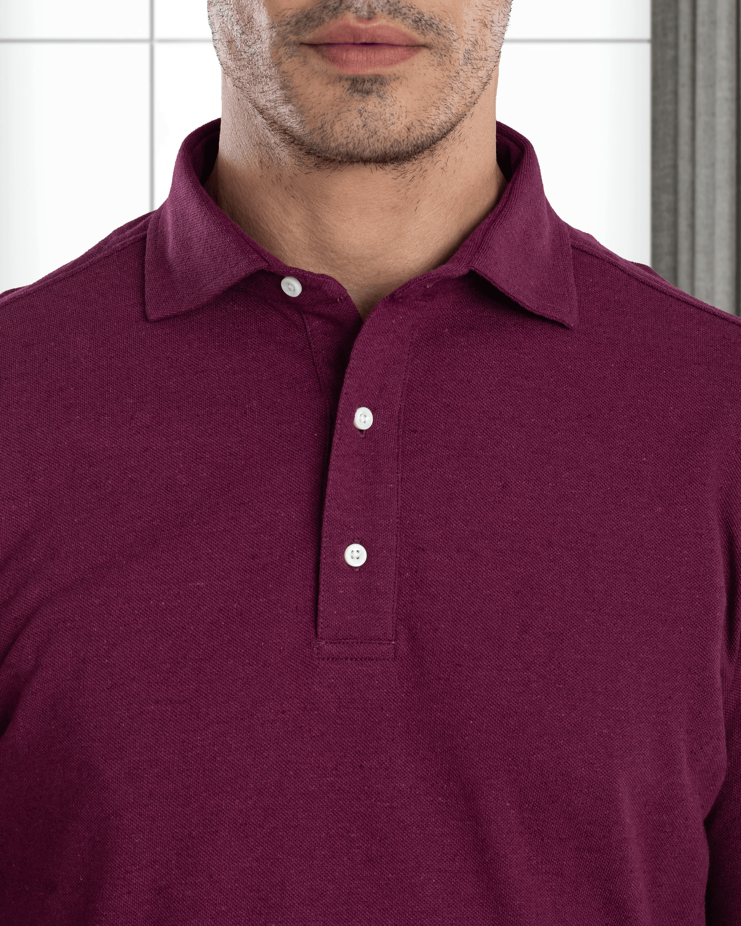 Close up of model wearing the custom oxford polo shirt for men by Luxire in purple