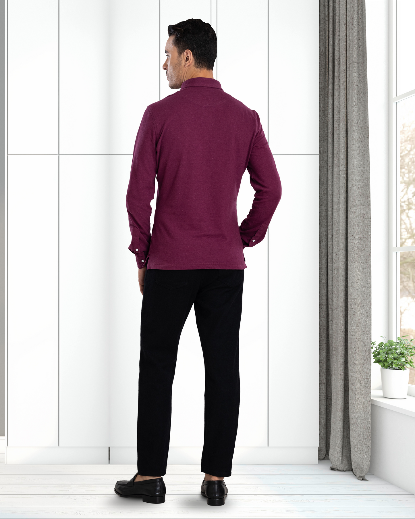 Back of model wearing the custom oxford polo shirt for men by Luxire in purple