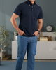 Model wearing the custom oxford polo shirt for men by Luxire in navy hands in pockets