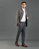 Side of model wearing the shirt jacket for men by Luxire in brown and grey overchecks