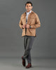 Front of model wearing the woolen flannel shirt jacket for men by Luxire in tan hands together