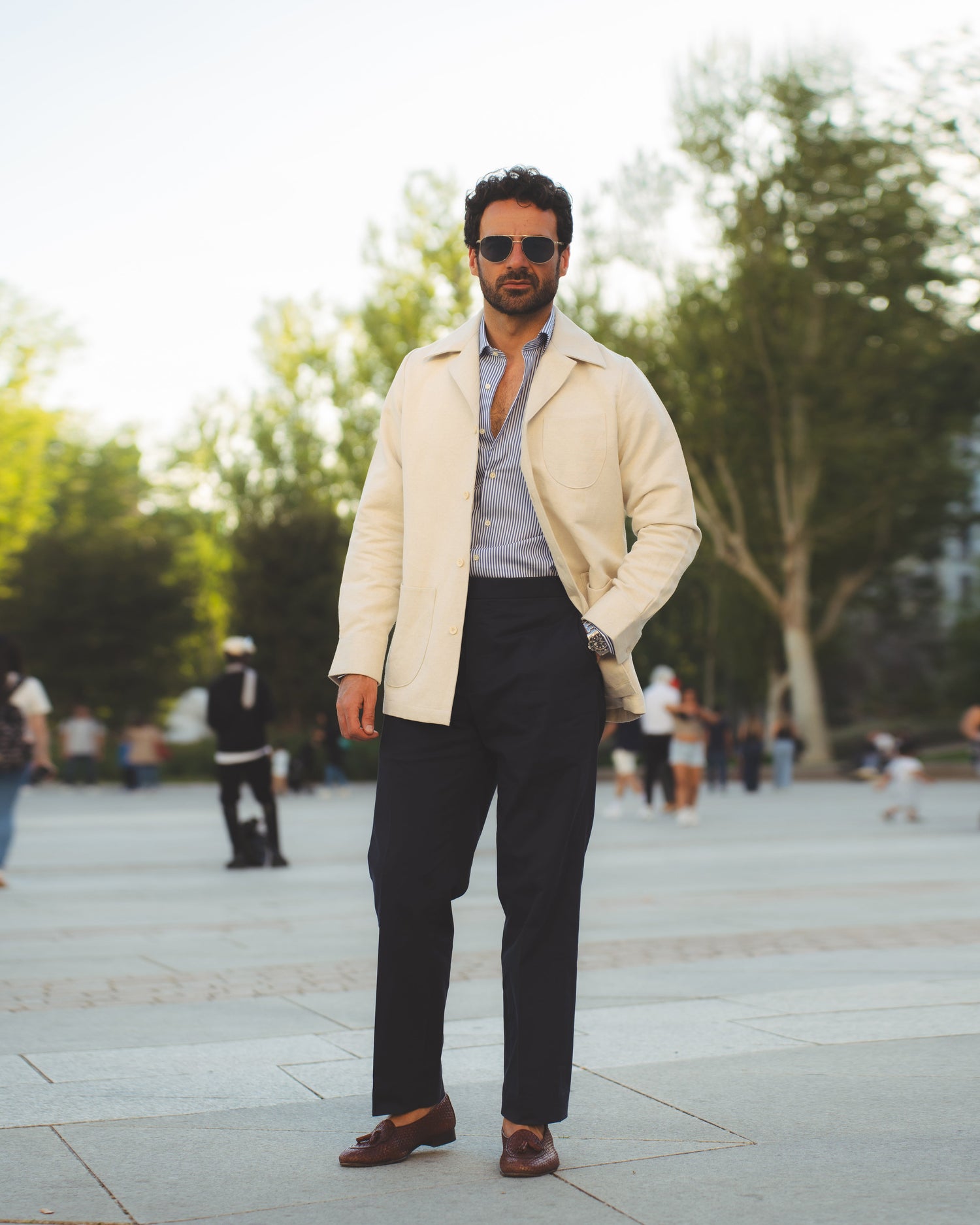 Model outside wearing the linen shirt jacket for men by Luxire in cream wearing sunglasses 16