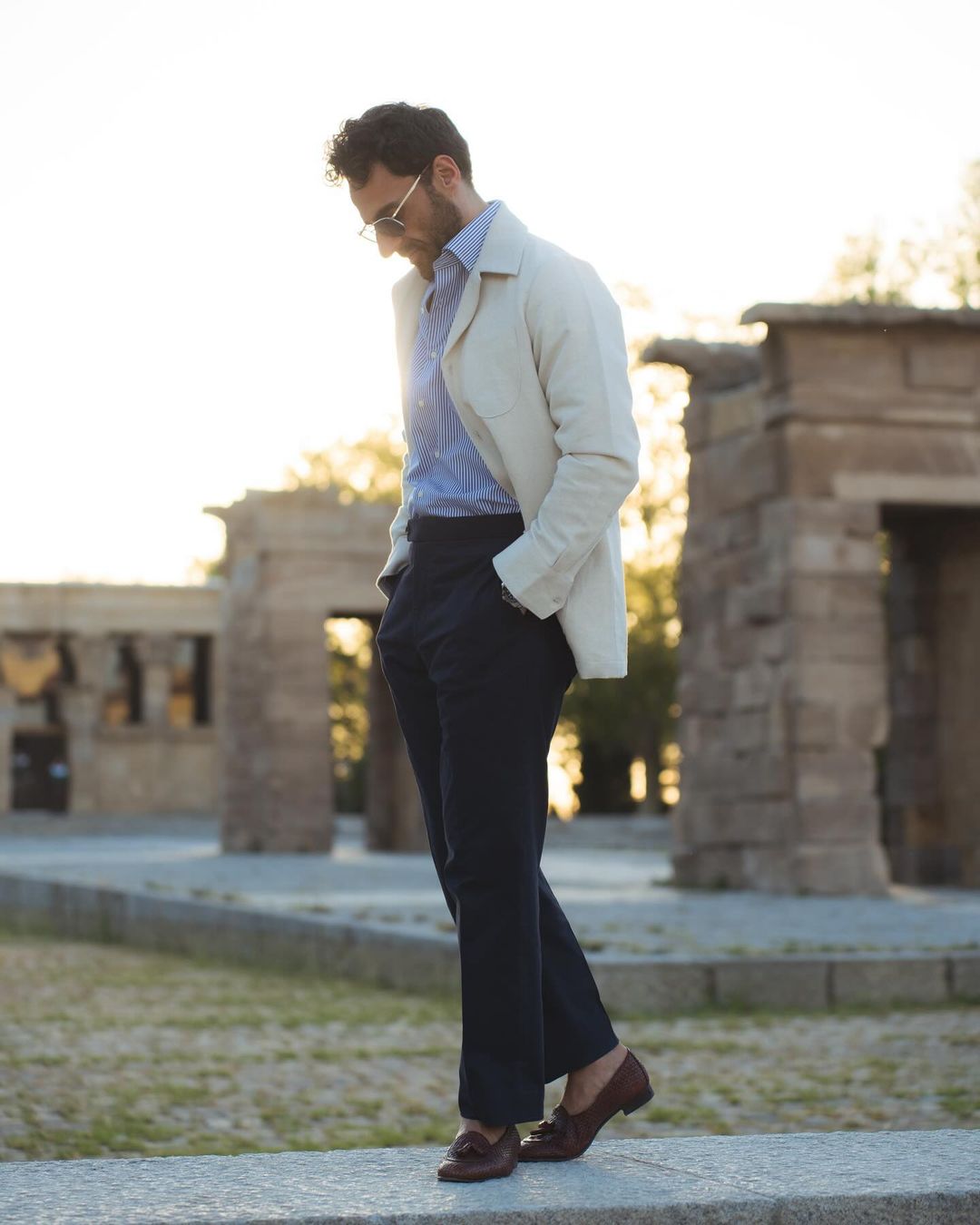 Model outside wearing the linen shirt jacket for men by Luxire in cream hands in pockets