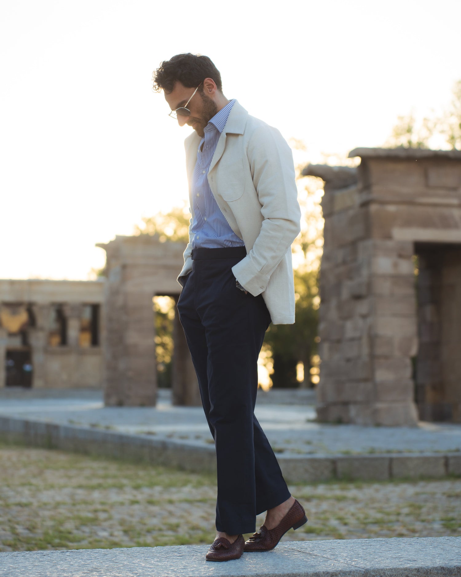 Model outside wearing the linen shirt jacket for men by Luxire in cream wearing striped shirt 9